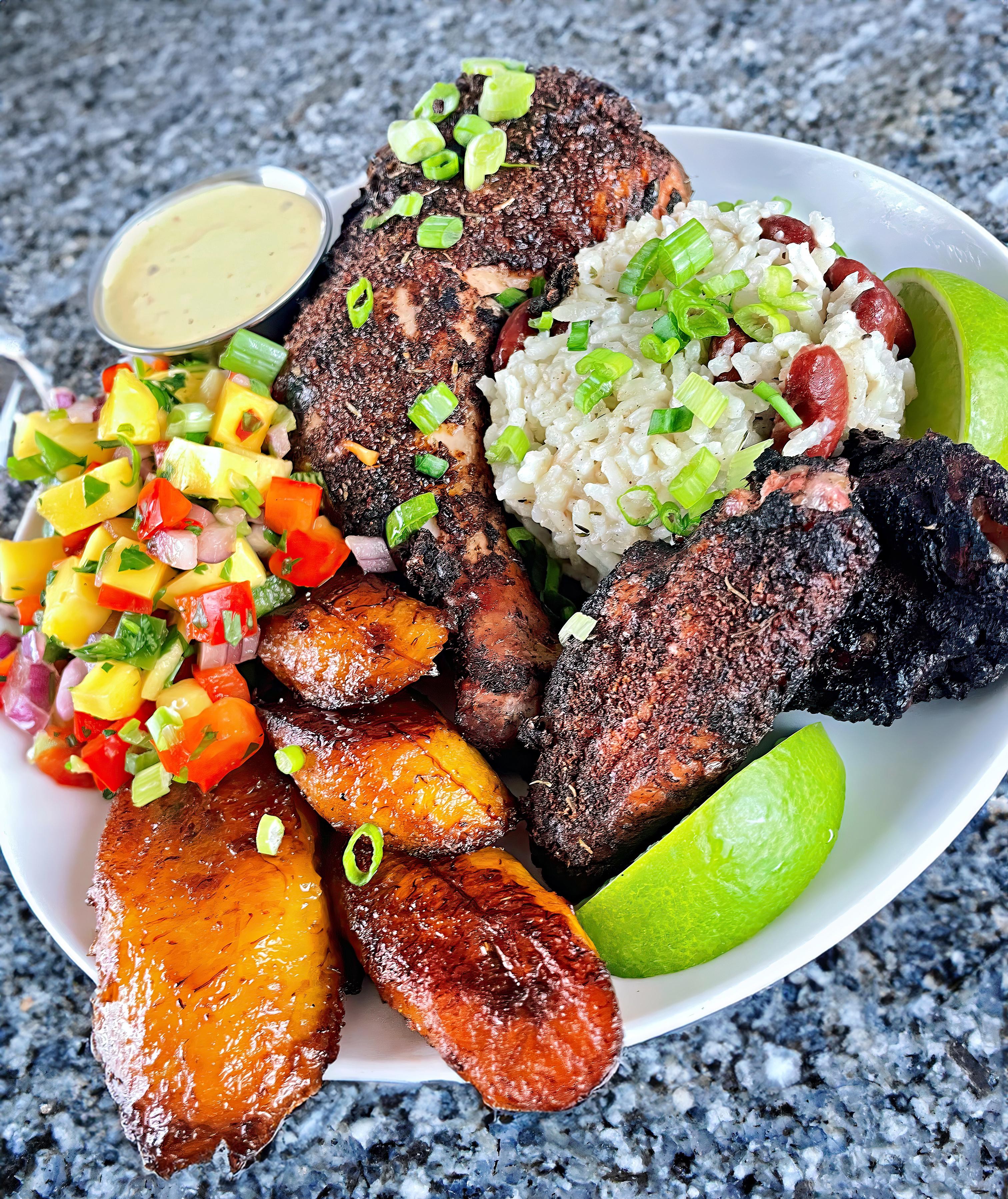 Jerk chicken and grilled plantains on a plate