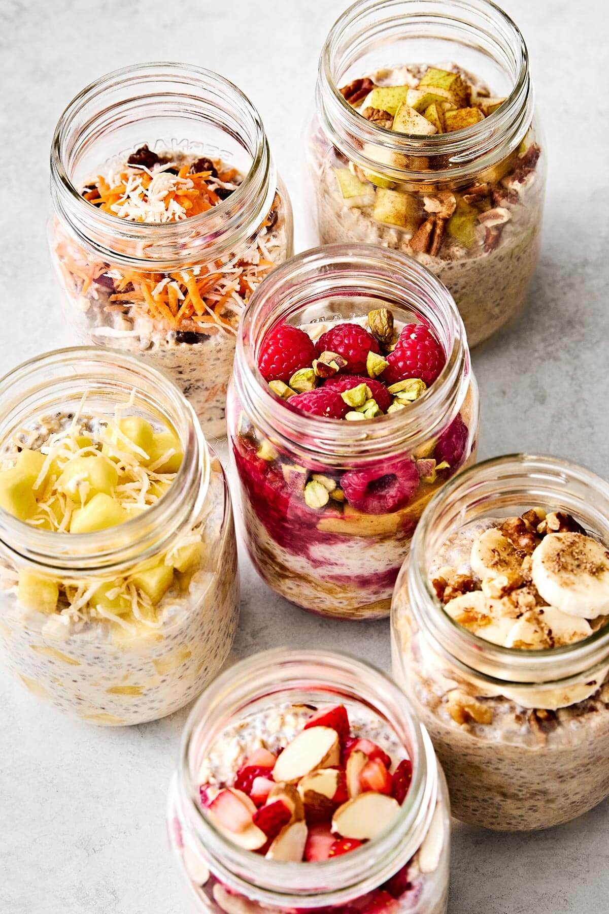 Overnight oats in a glass jar with various fruits and nuts