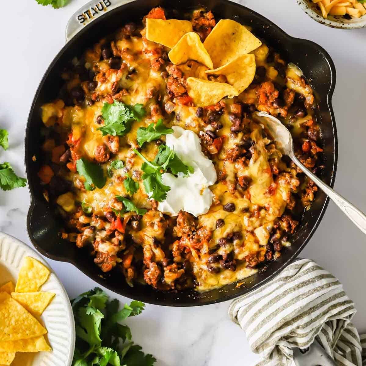 Vibrant ground beef taco skillet topped with fresh cilantro and cheese, a quick weeknight meal