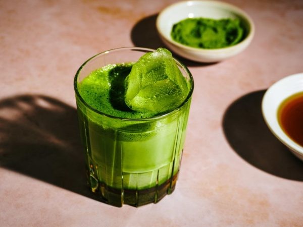 frothy matcha latte with maple syrup drizzle