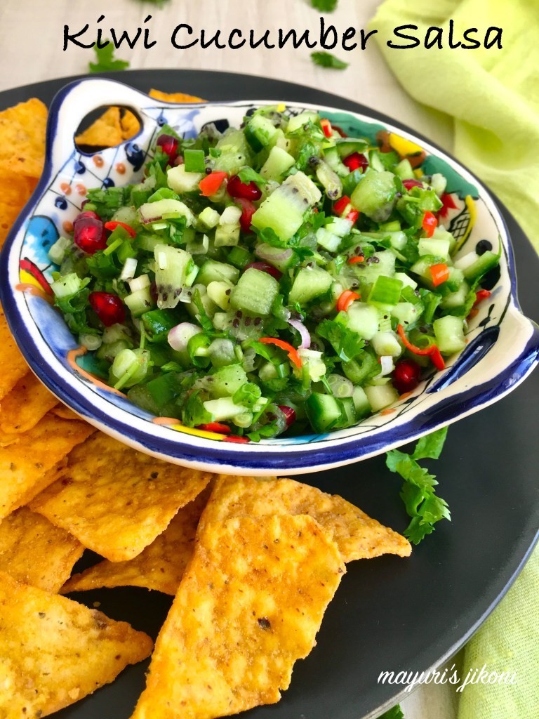 close up shot of cucumber kiwi salsa salad in a white bowl