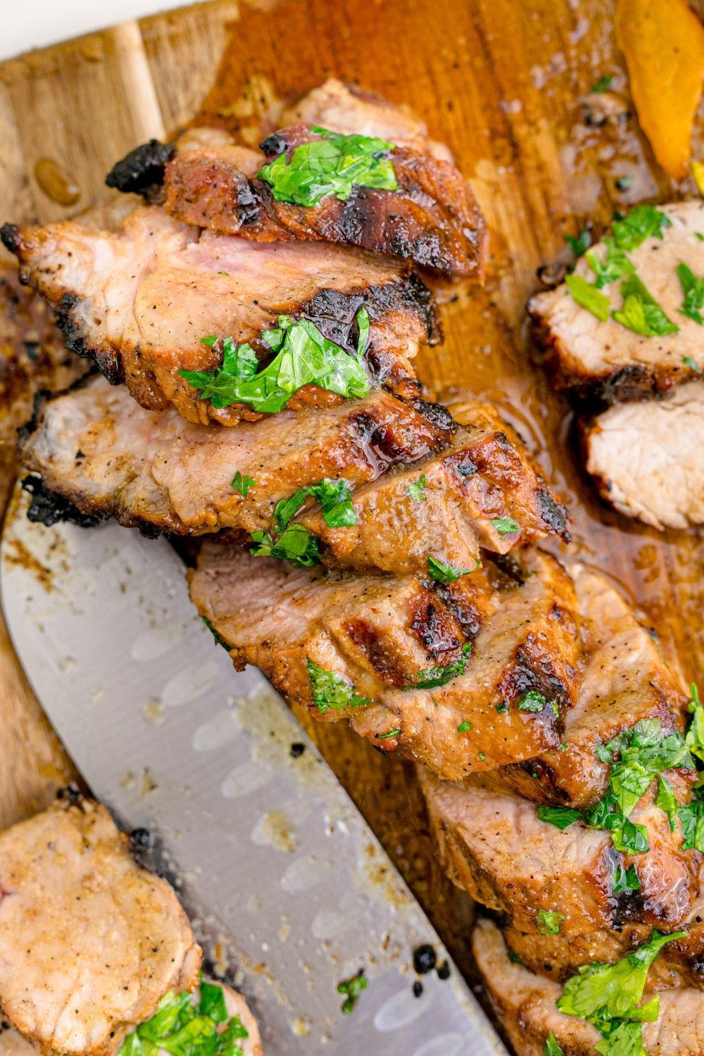 griddle-grilled pork tenderloin on a wooden cutting board