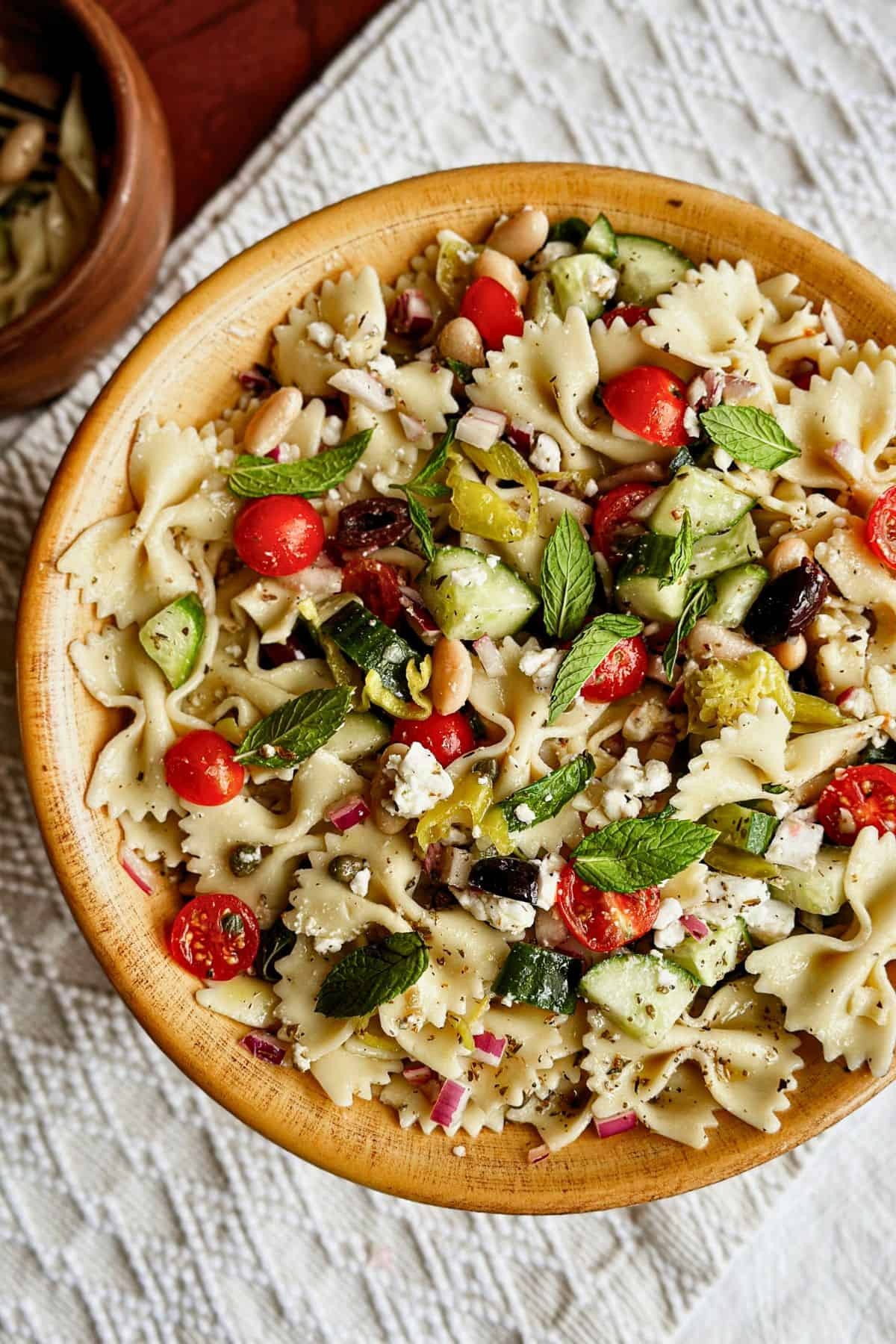 Fresh Greek Pasta Salad with Cranberry and Thyme served in a bowl outdoors