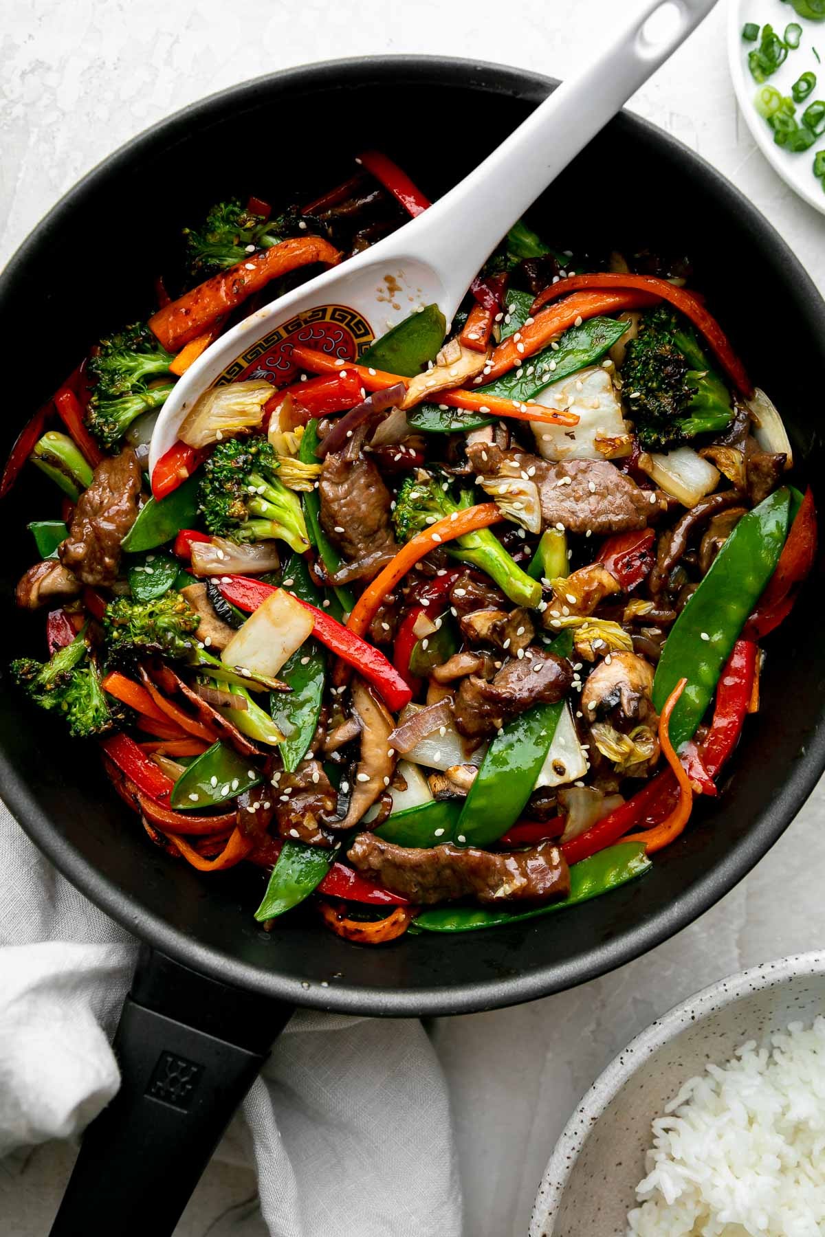 Spicy beef stir-fry with vibrant vegetables served in a dark bowl
