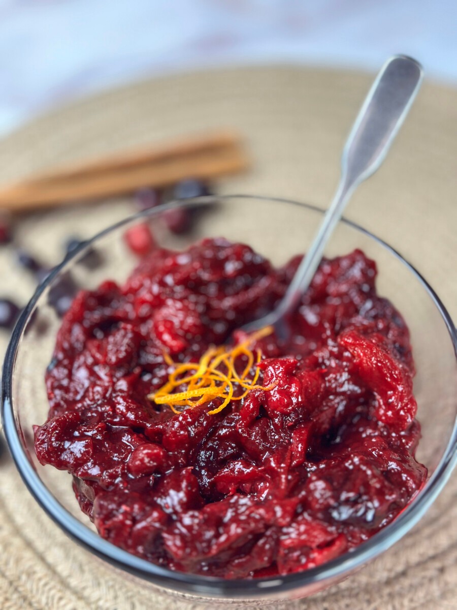 vibrant homemade cranberry sauce with fresh ginger and orange zest, festive holiday table