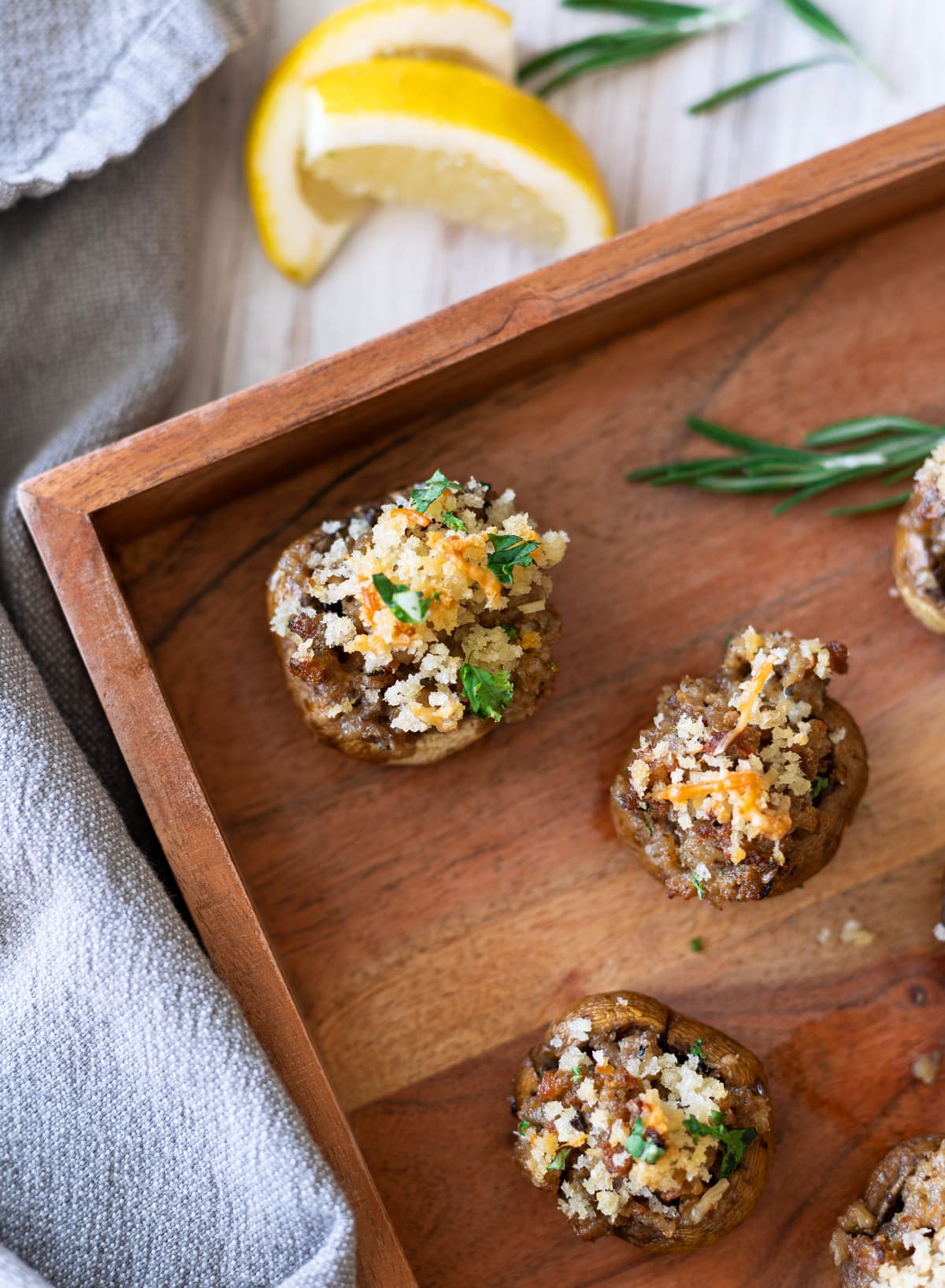 close up of street corn stuffed mushrooms on a wooden board