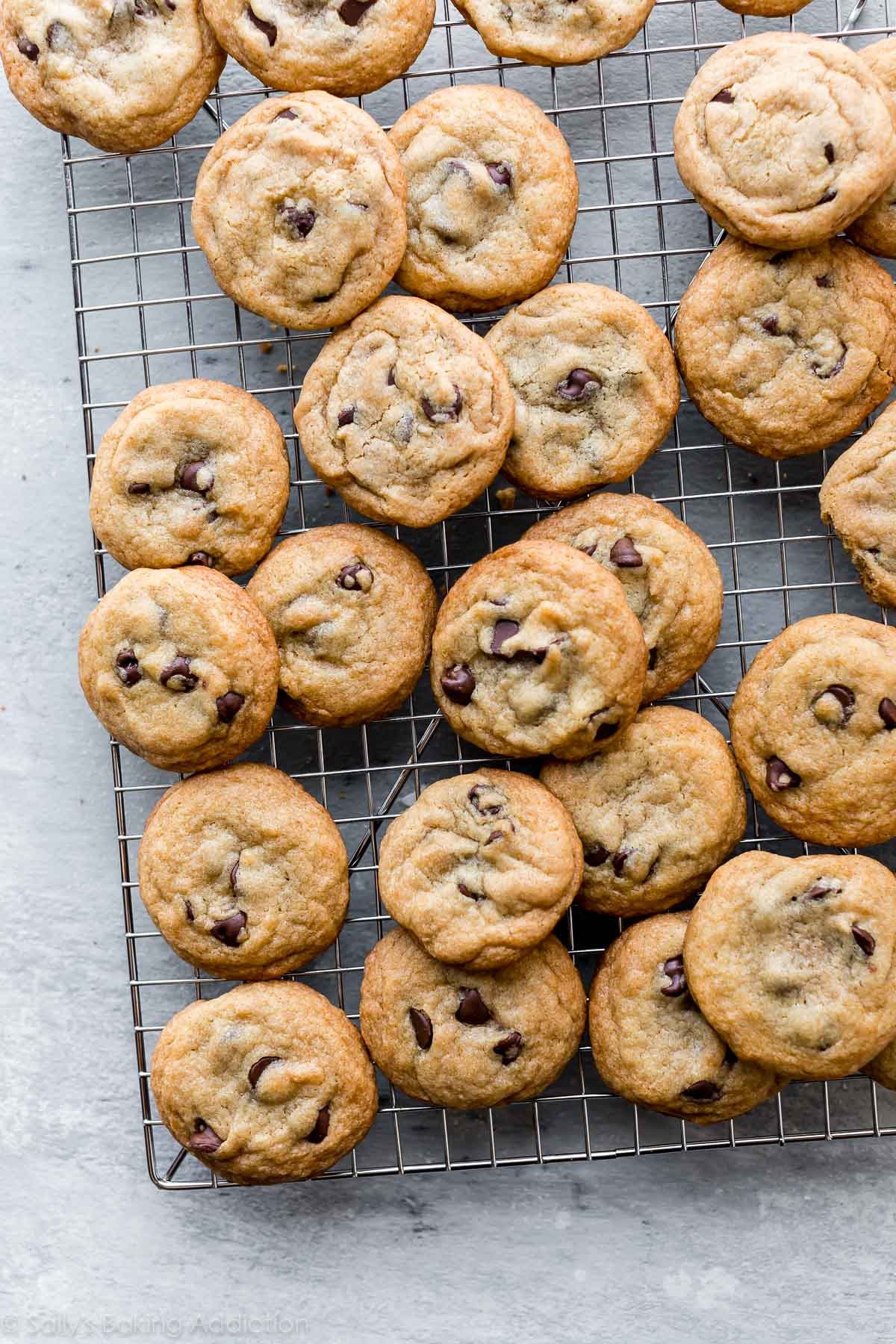 Close-up of crispy-edged chocolate cookies on a cooling rack, fresh out of the oven