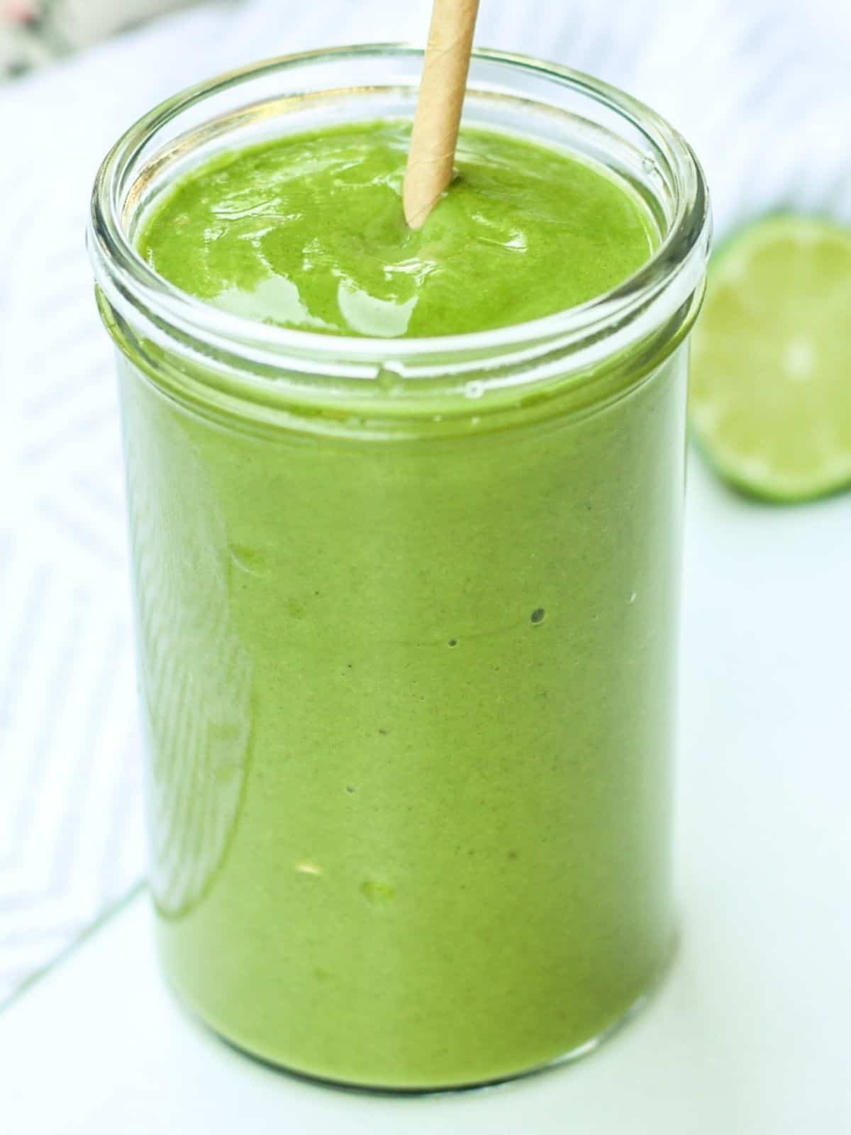 vibrant green smoothie with papaya chunks and spinach