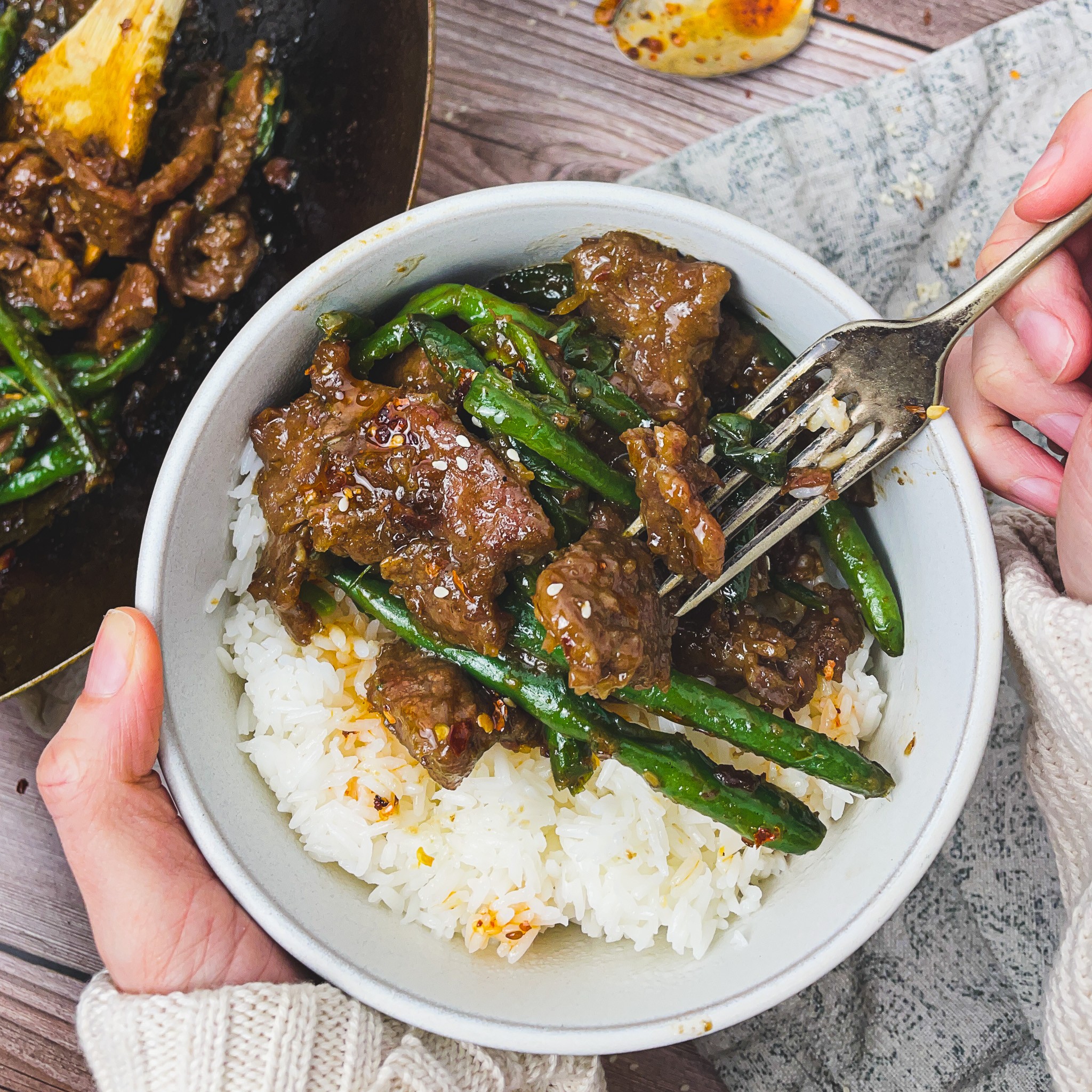 bowl of beef and green beans served over rice