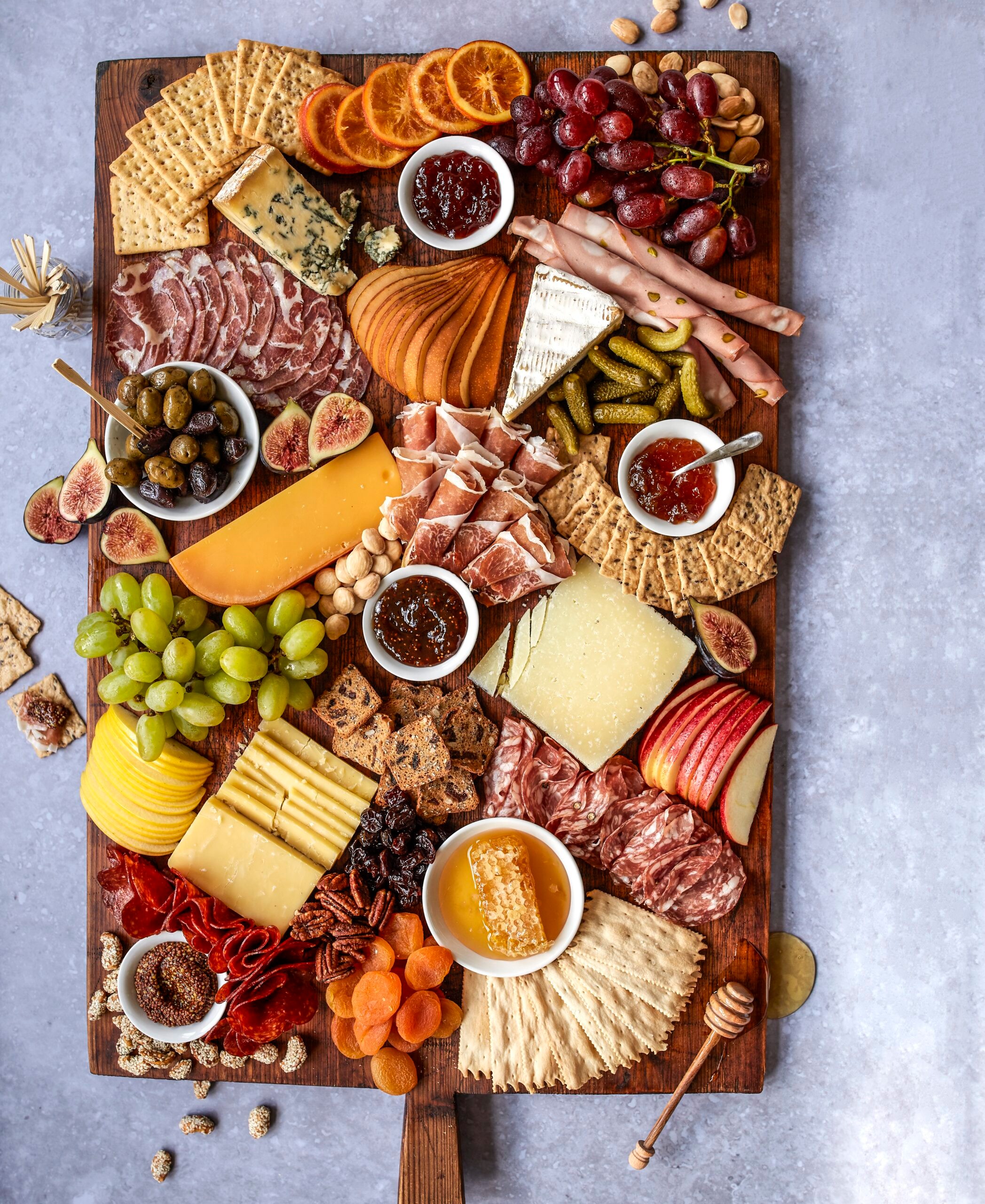 a beautifully arranged cheese flight on a wooden board
