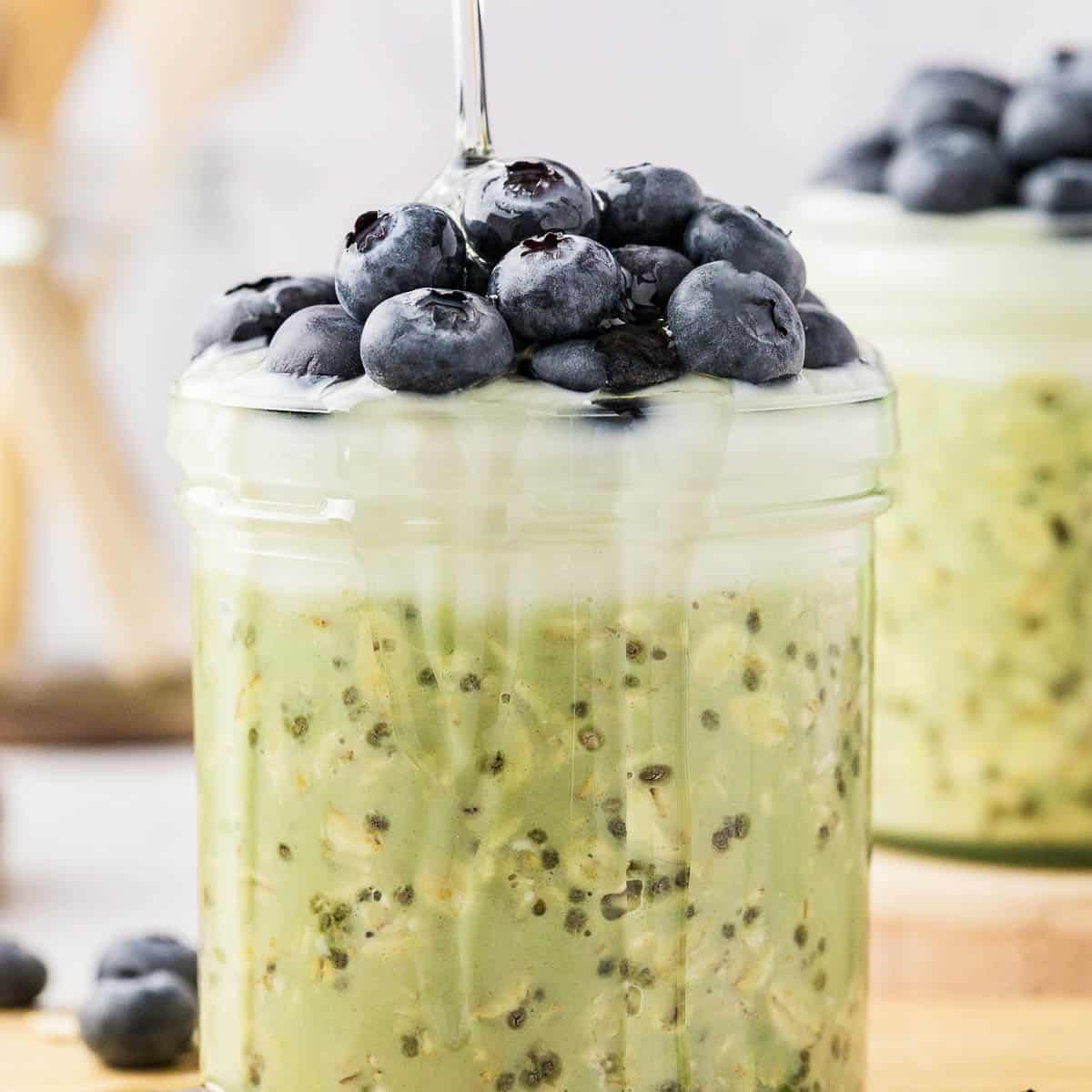 jasmine green tea overnight oats in a jar with fresh berries