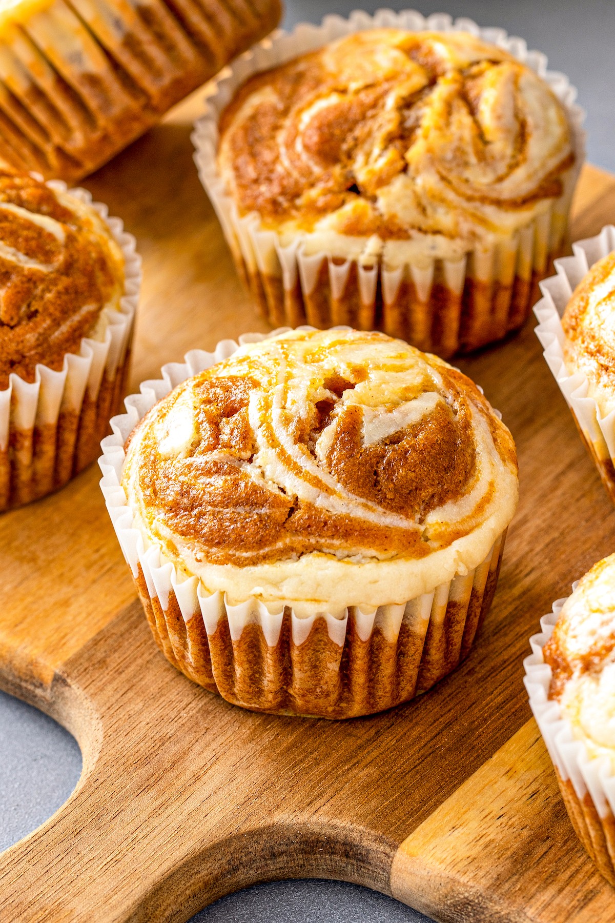 freshly baked pumpkin muffins with cream cheese swirl