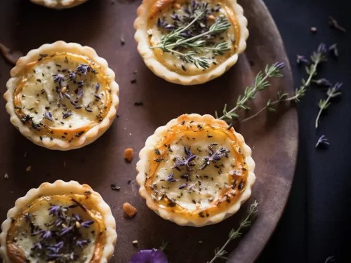 lavender blueberry goat cheese tart on a rustic wooden surface