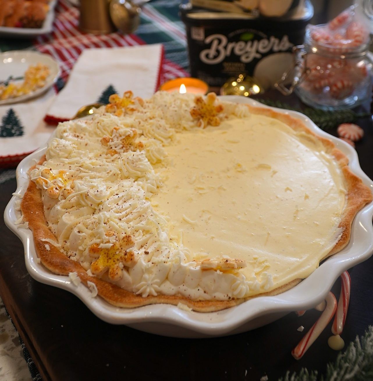 Festive eggnog custard pie with whipped cream and nutmeg, holiday dessert