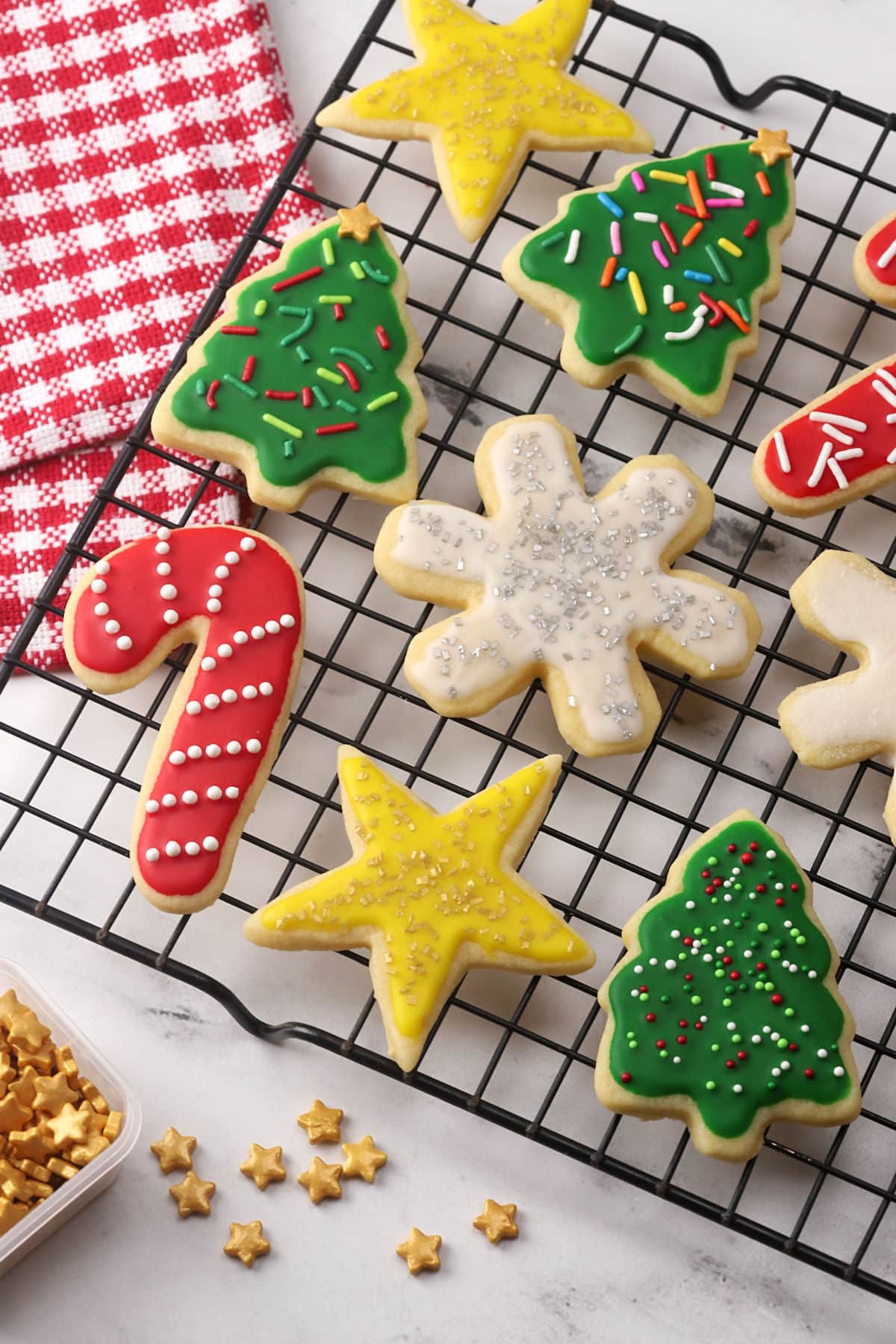 beautifully decorated cut out sugar cookies on a cooling rack, festive background