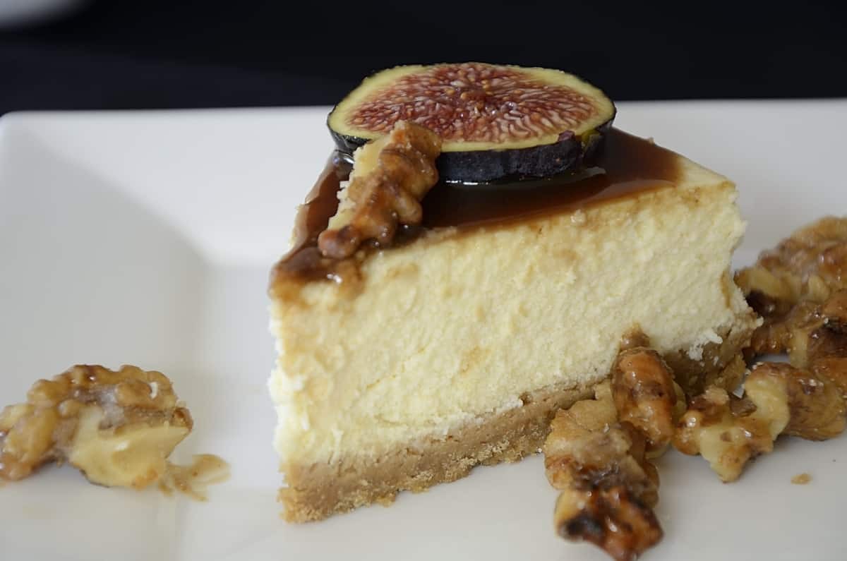 Fig balsamic cheesecake slice on a white plate