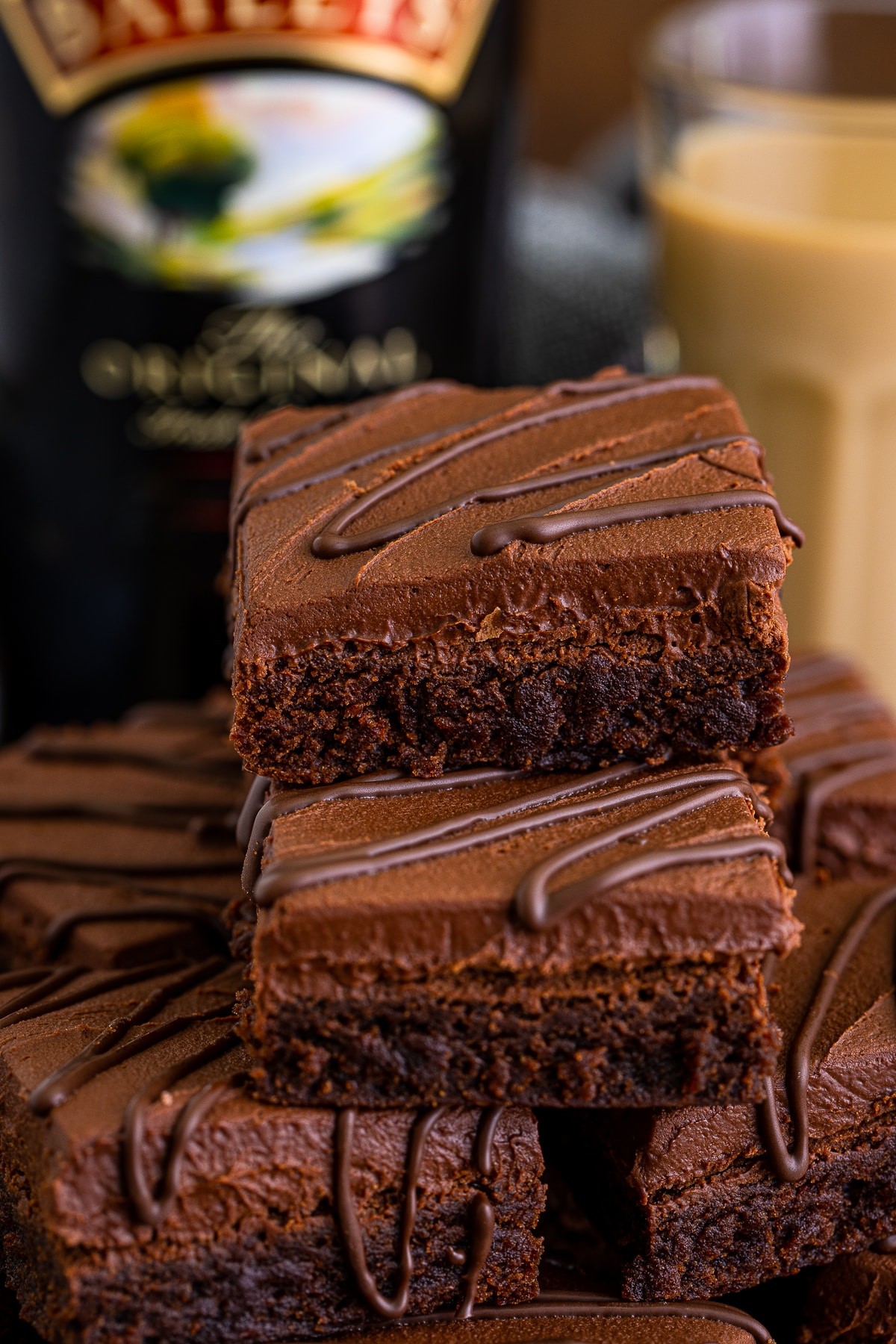 Baileys brownies topped with chocolate ganache and a drizzle of Baileys Irish Cream