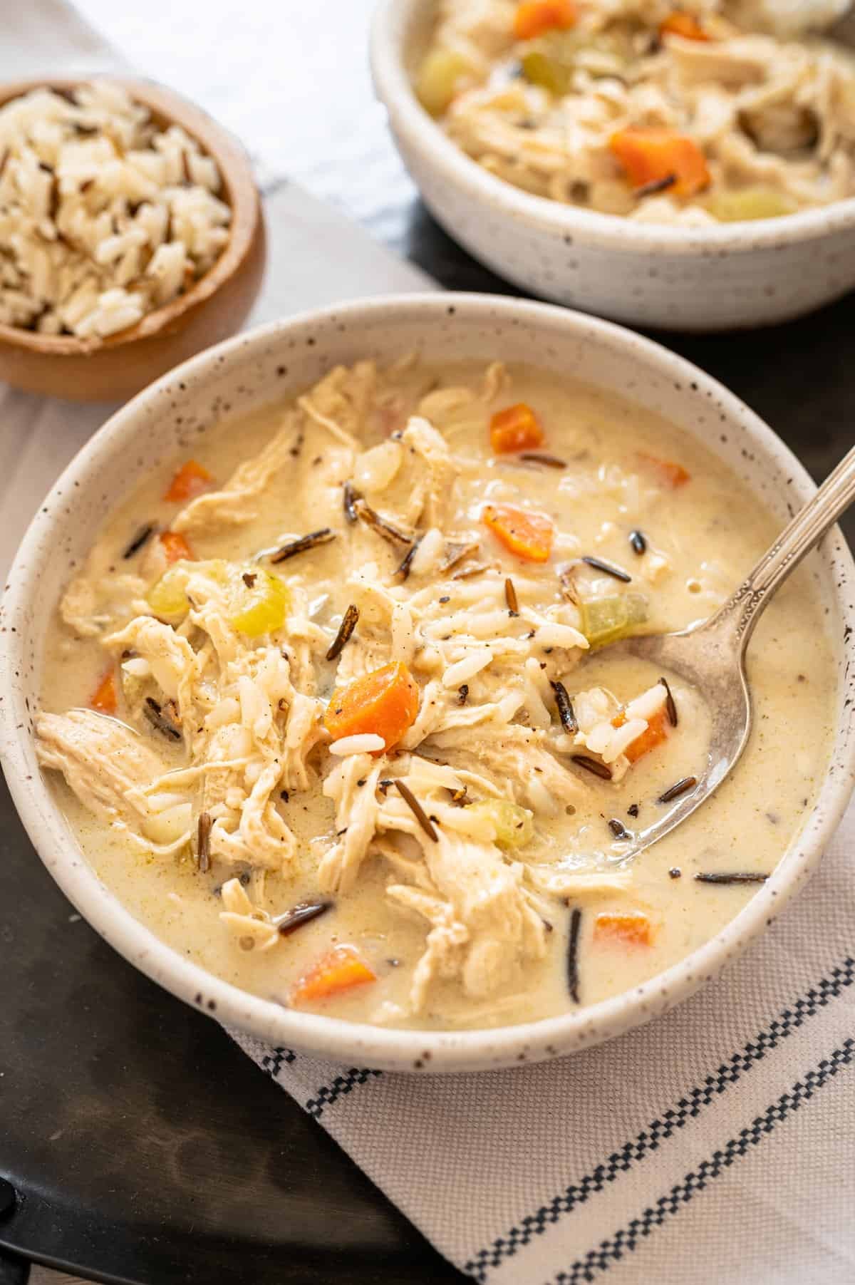 bowl of chicken and wild rice soup with freezer bags in the background