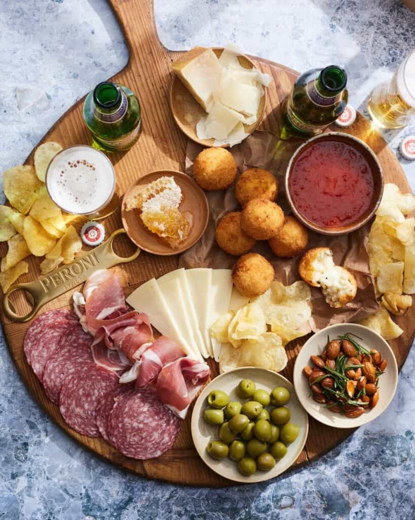 cheese platter with arancini and wine