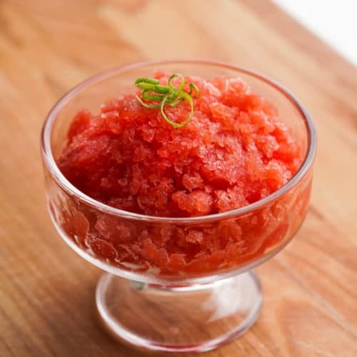 close up of vibrant watermelon granita in a glass bowl