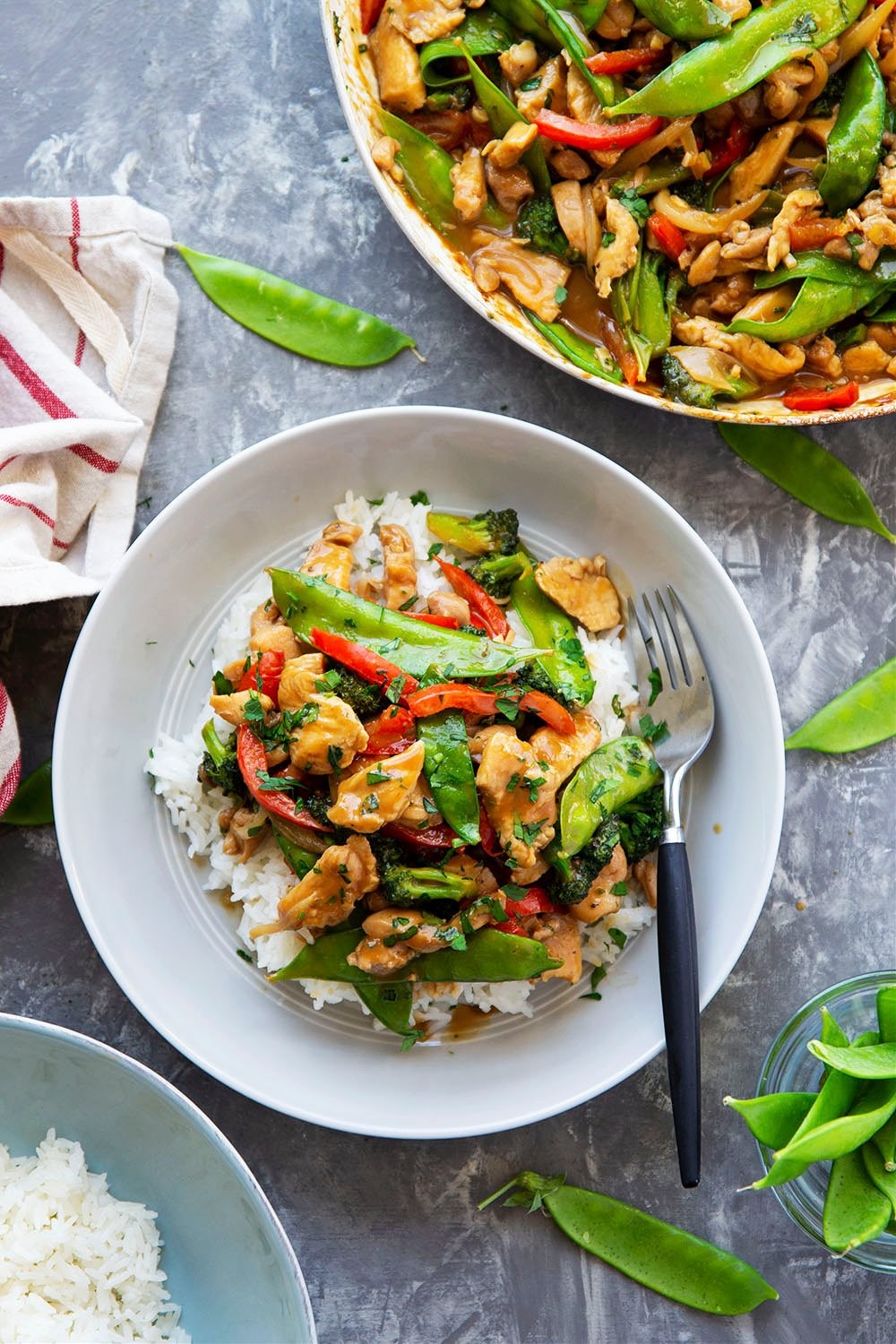 Peanut satay chicken and spinach stir-fry in a wok