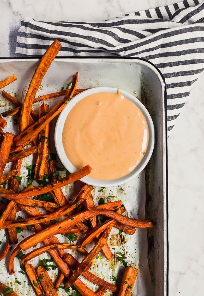 close up of roasted carrot fries with dipping sauce