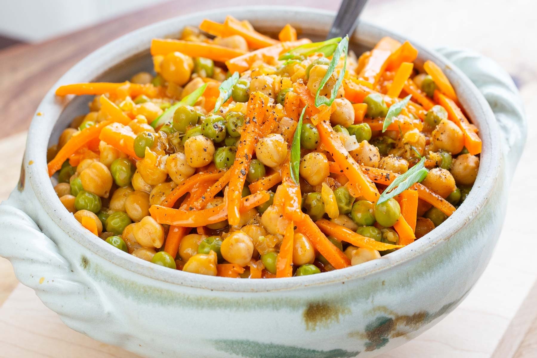 overhead shot of a vibrant chickpea curry in a rustic bowl