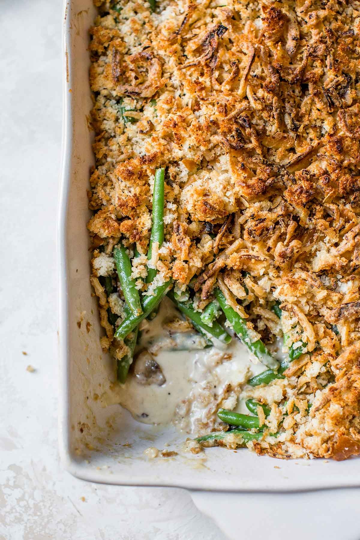 rustic skillet green bean casserole with golden crispy topping and fresh herbs