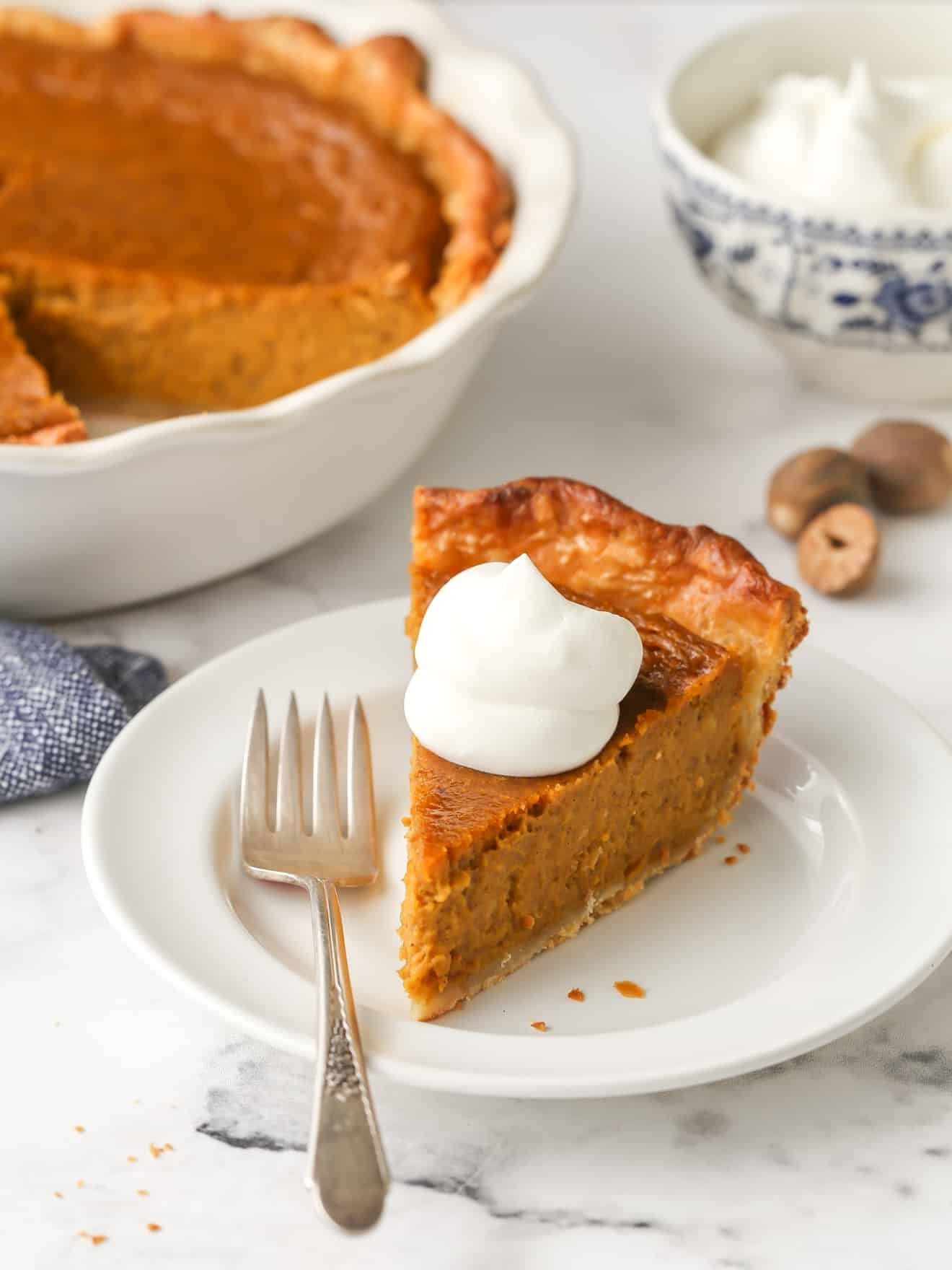 beautiful creamy pumpkin pie with flaky butter crust, autumn setting