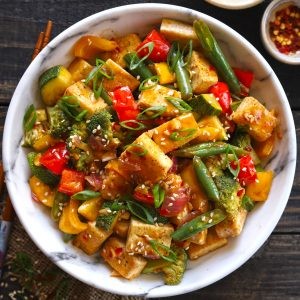 Colombian tofu stir-fry with colorful vegetables served in a rustic bowl