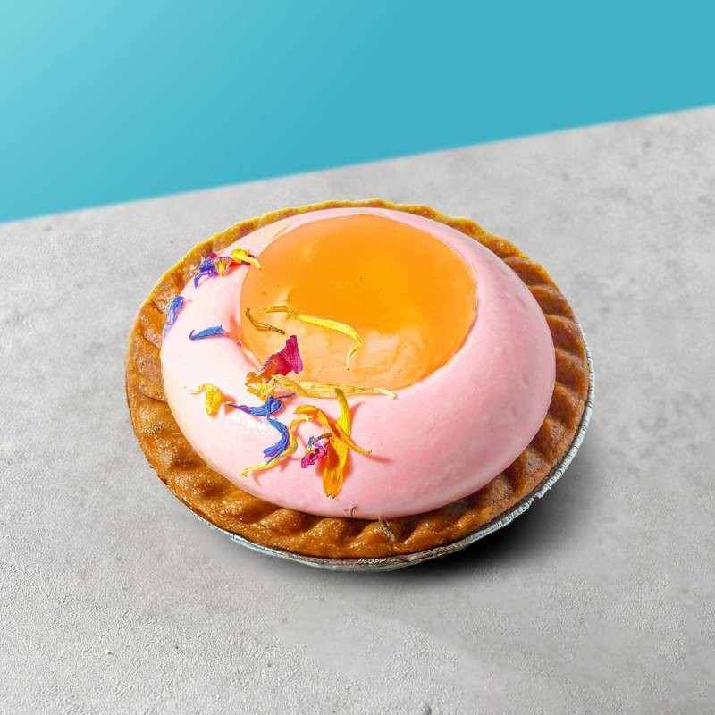 lychee rose tart on a marble surface, garnished with rose petals