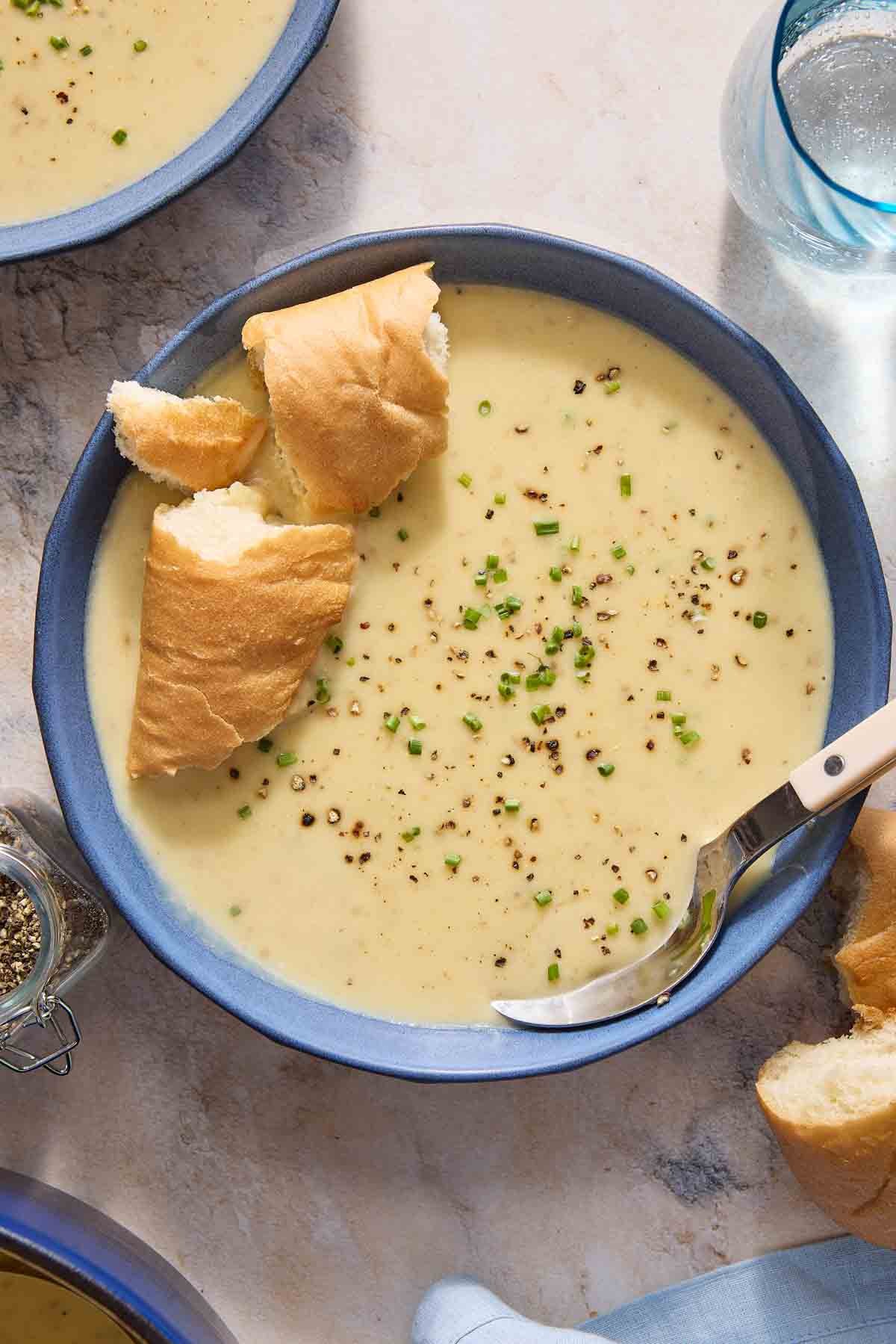 hearty creamy potato leek soup bowl with crusty bread