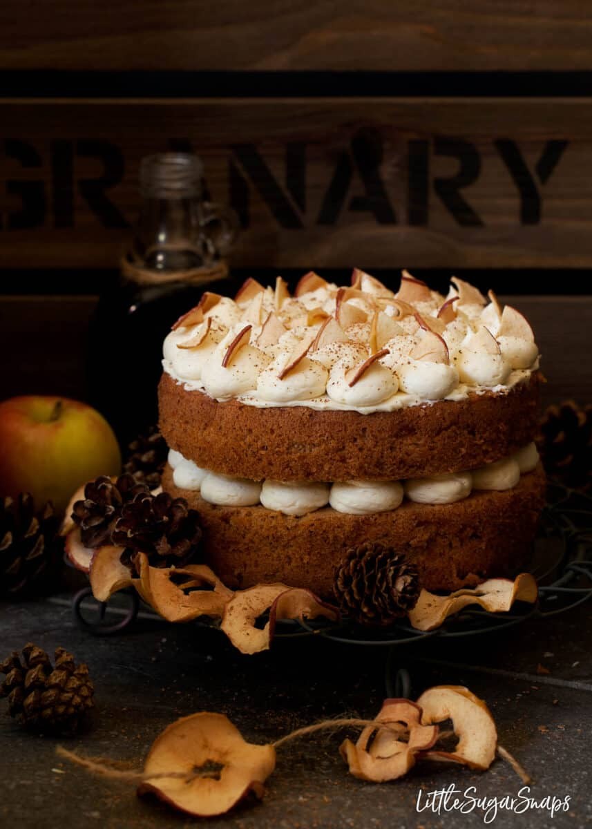 cinnamon apple cake with a slice cut out, autumn leaves background