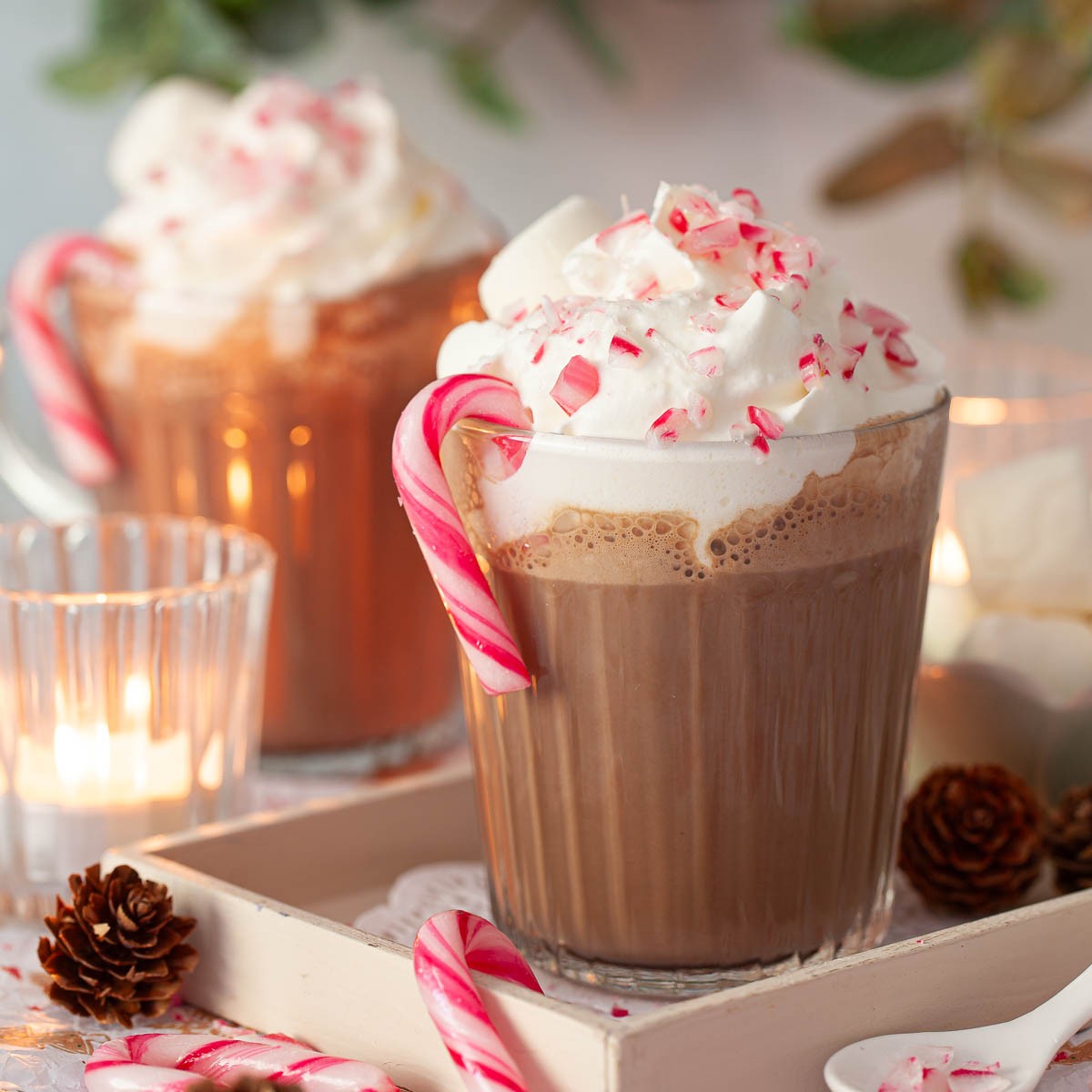 Vibrant peppermint mocha with whipped cream and candy cane garnish, festive setting