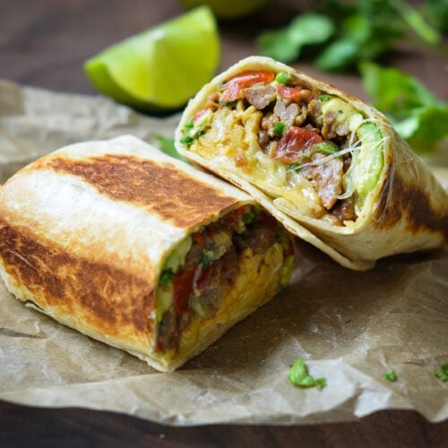 vibrant close-up of a golden brown, melted cheese breakfast burrito, with fresh salsa and avocado on the side, morning light