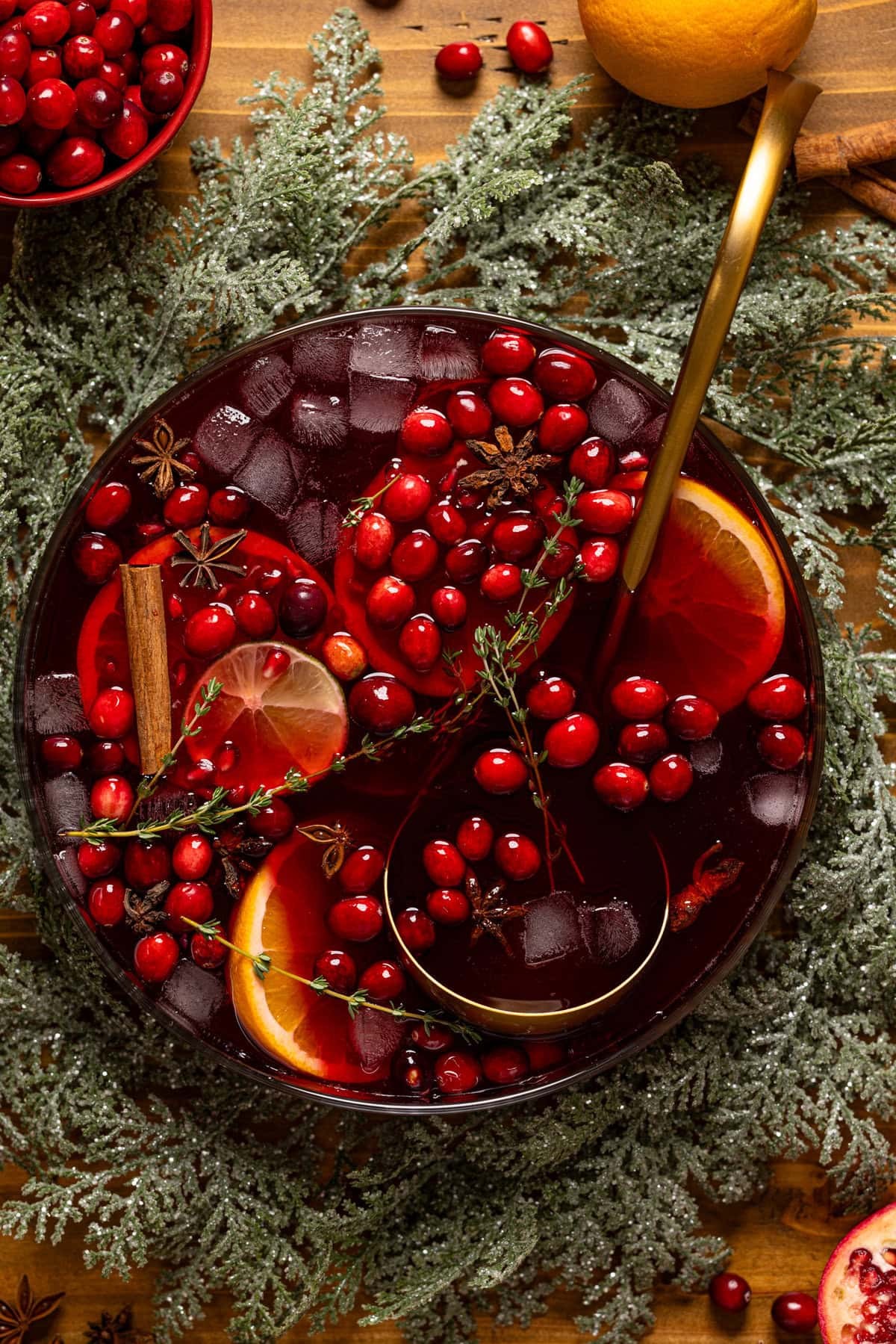 vibrant spiced rum punch with citrus slices and cranberries in a large punch bowl, festive holiday setting
