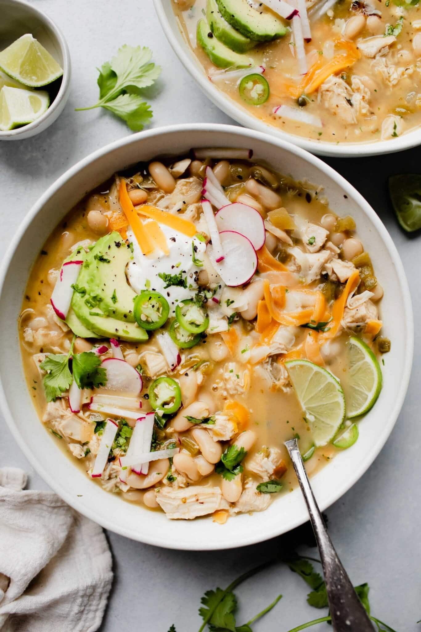 bowl of white chicken chili with toppings