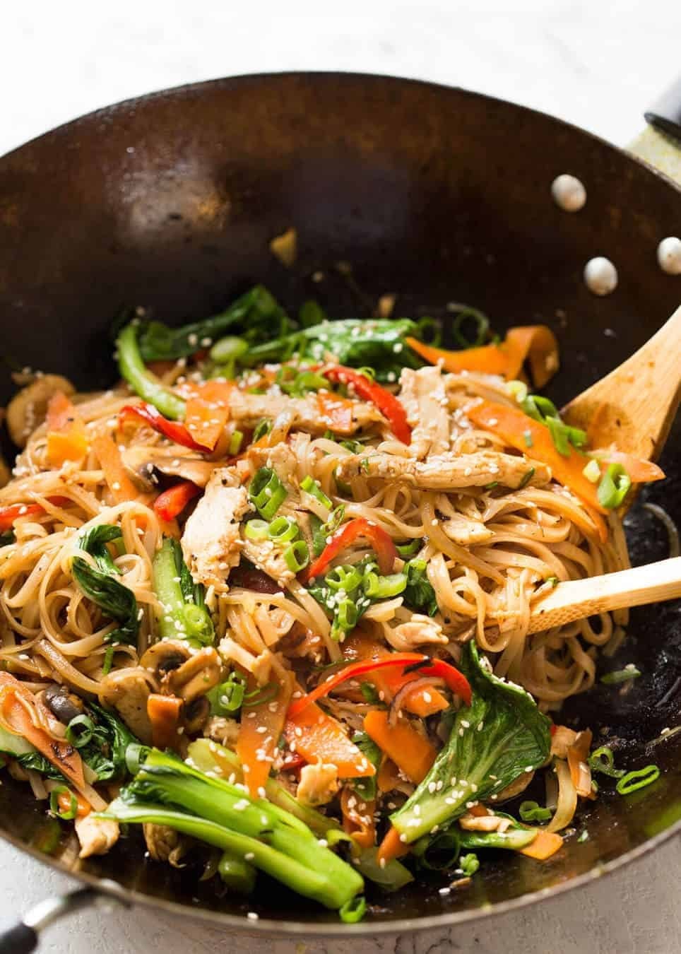 Spicy chicken and rice noodle fried rice in a wok