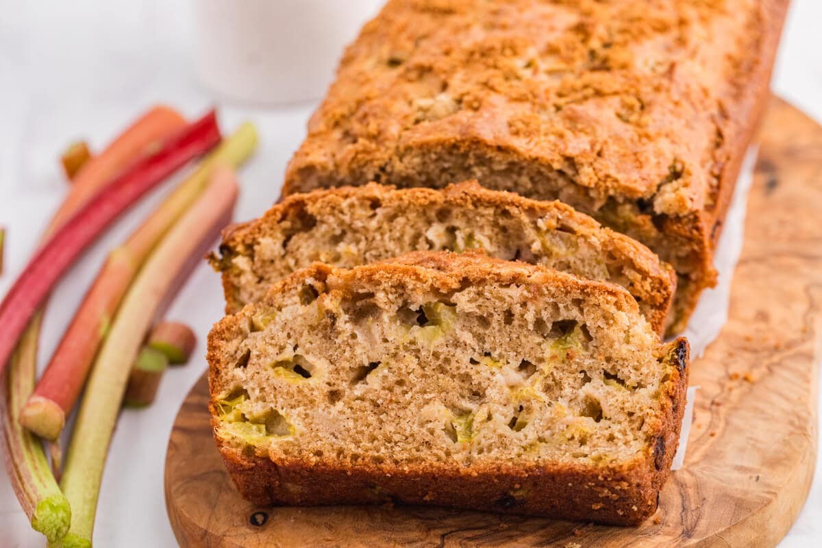 slices of coconut rhubarb bread on a wooden cutting board