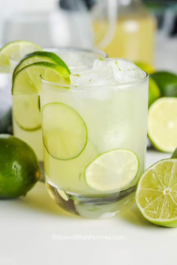 pitcher of homemade limeade with limes and ice