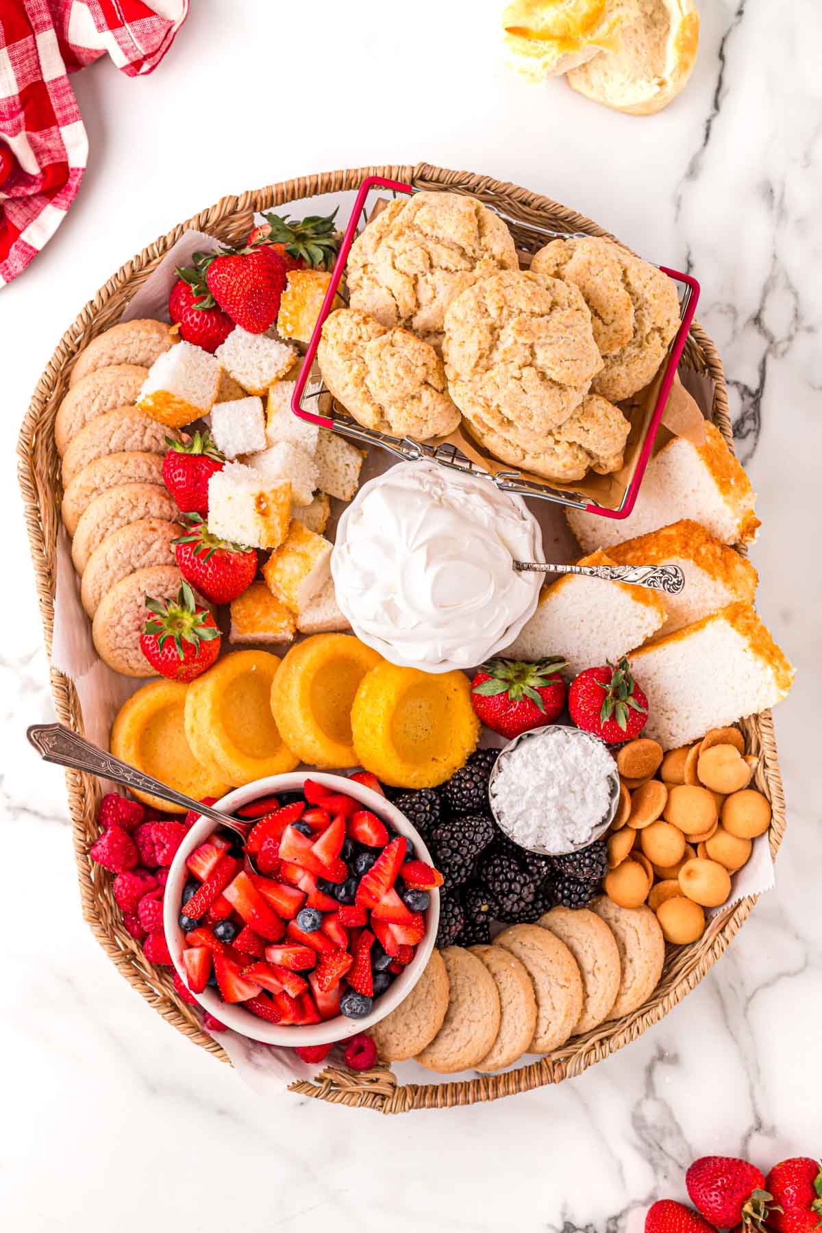 Strawberry shortcake bites arranged on a rustic wooden board