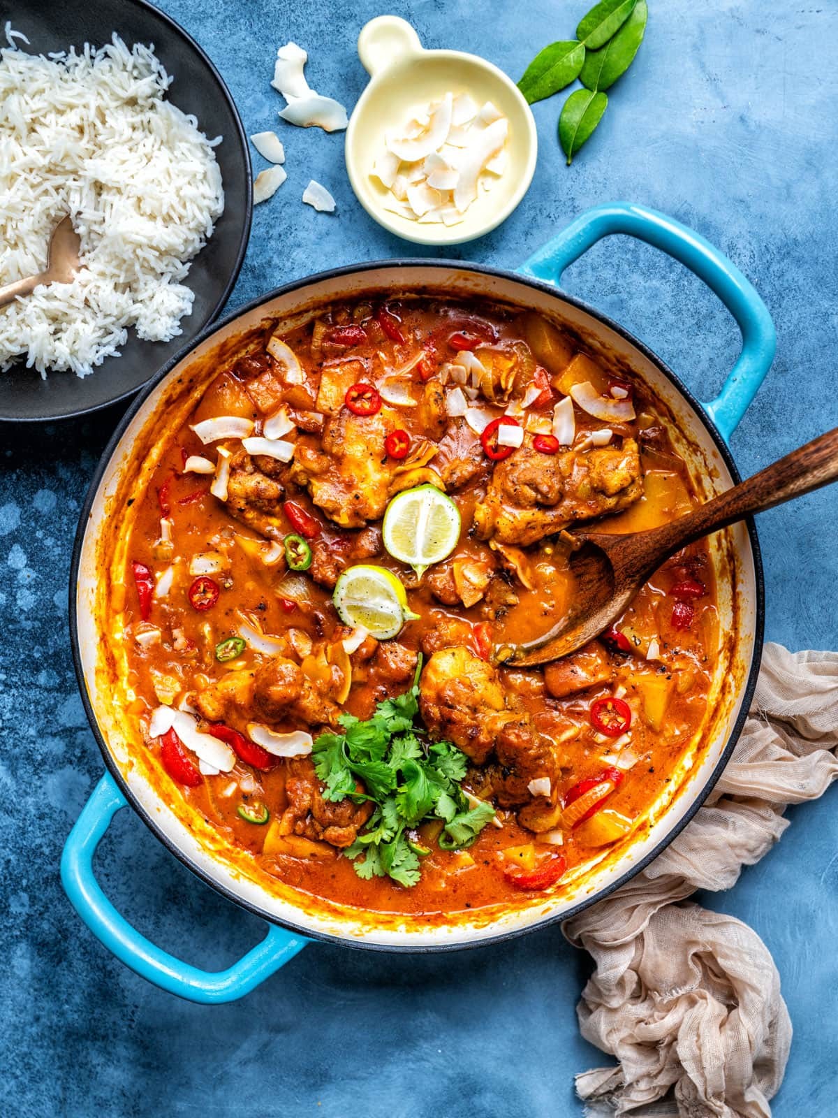 A vibrant bowl of chicken and vegetable curry served over brown rice, garnished with fresh cilantro