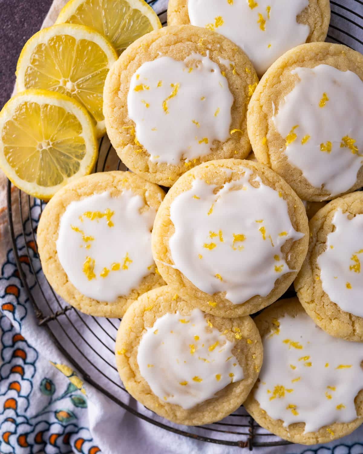 Close up of frosted sugar cookies with lemon glaze, bright and inviting, on a cooling rack