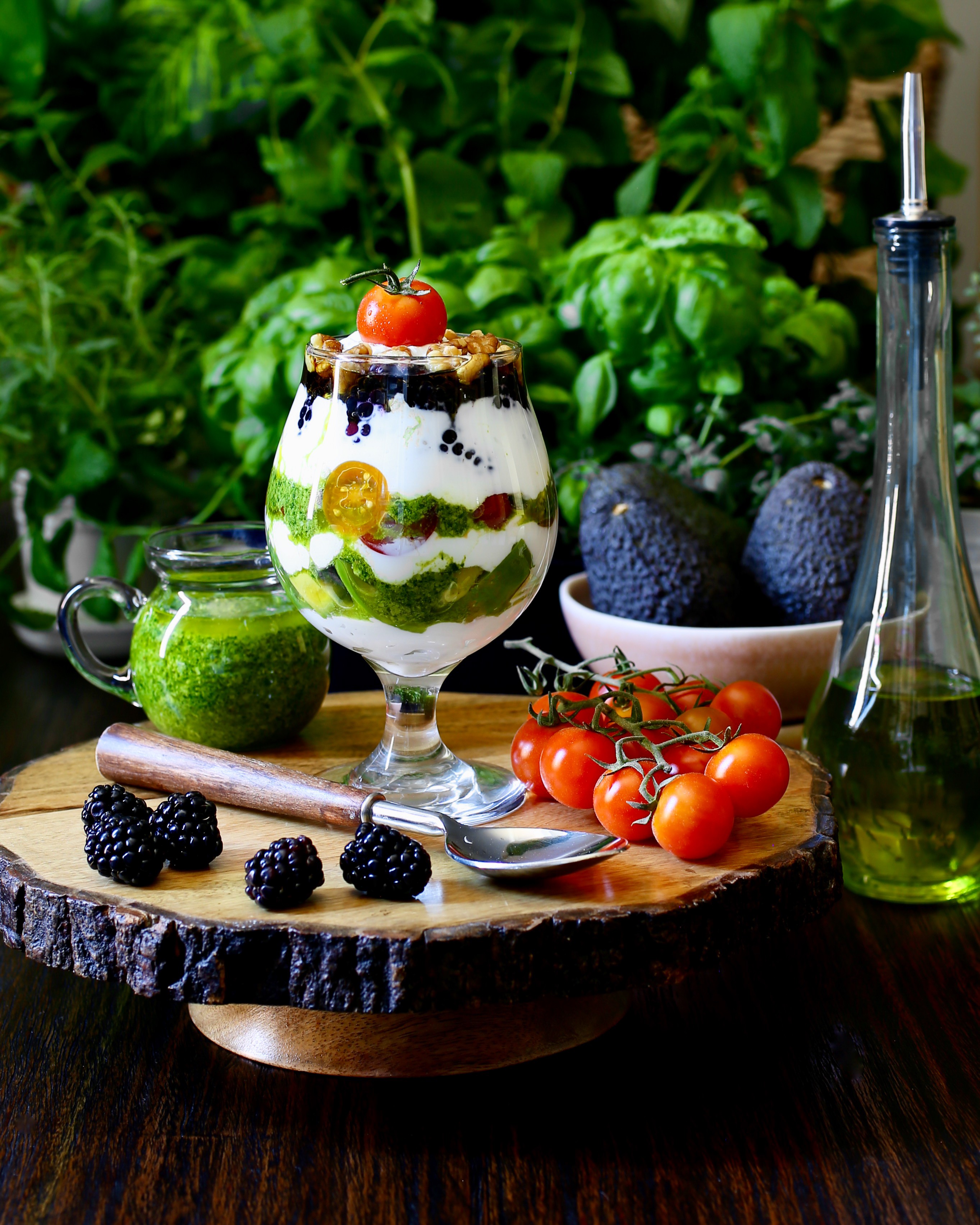 Garlic rice parfait topped with yogurt and herbs in a clear glass
