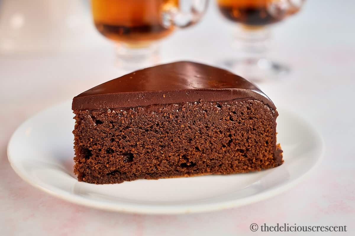 Decadent almond flour chocolate cake slice with rich ganache, close-up, natural light