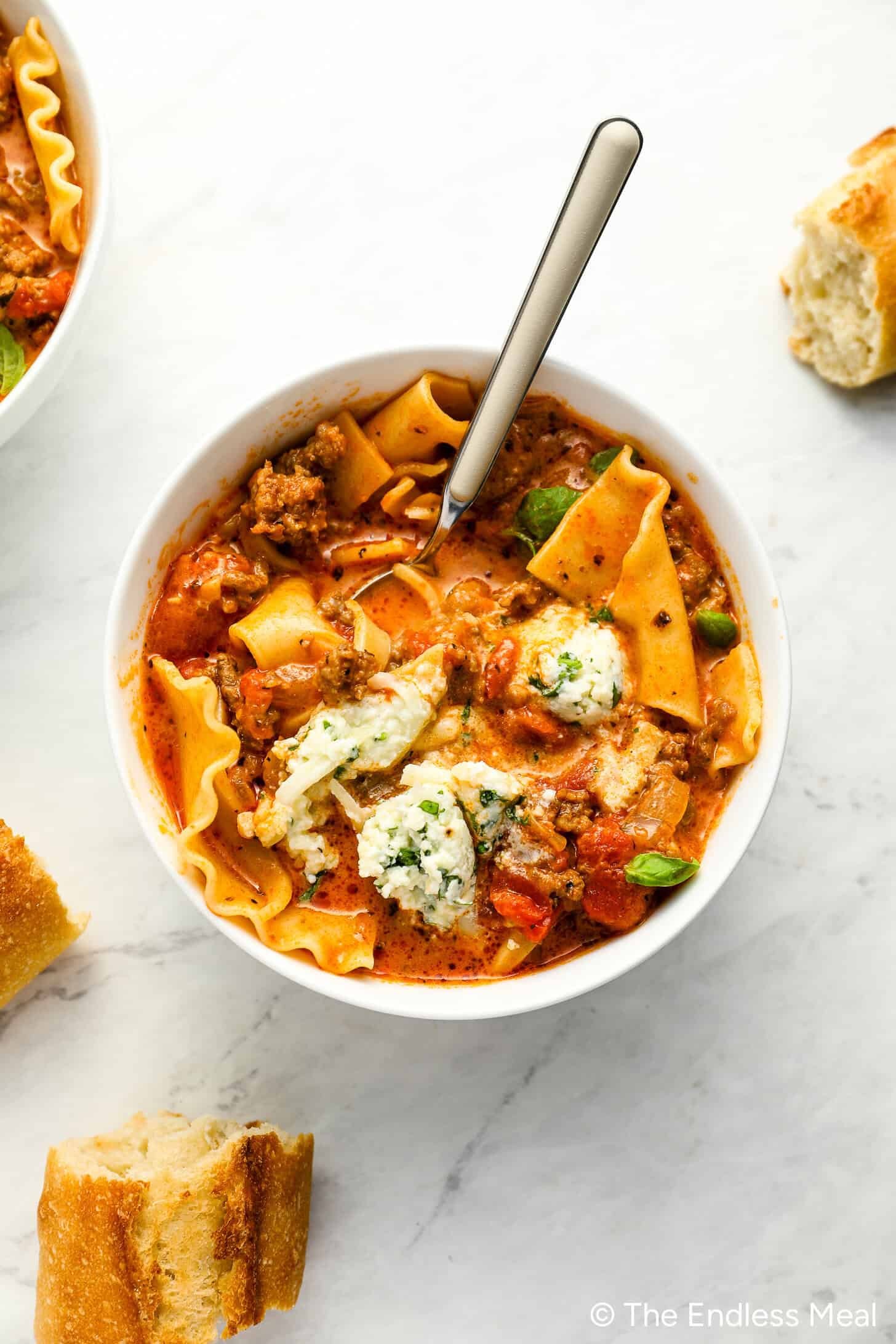 bowl of creamy lasagna soup with ricotta and basil