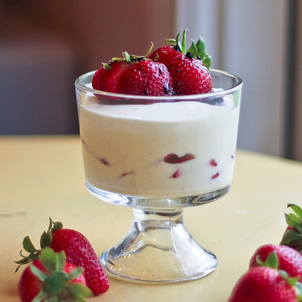 close up shot of white balsamic strawberry mousse in a glass