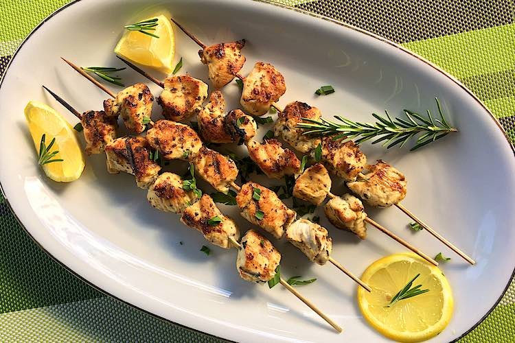 grilled lemon herb chicken skewers on a platter
