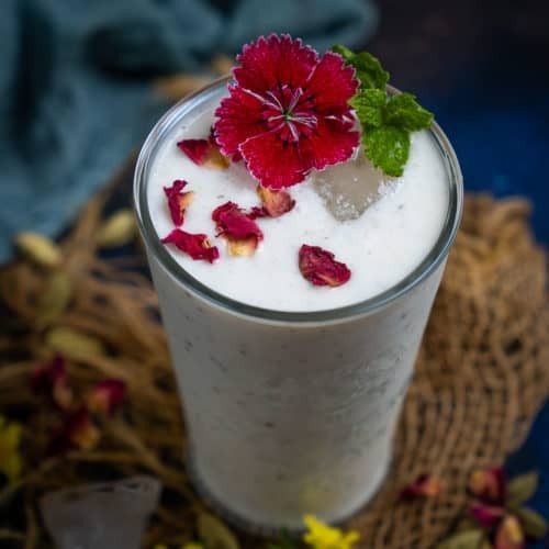 a refreshing Dill Delight Lassi in a glass, garnished with fresh dill sprigs