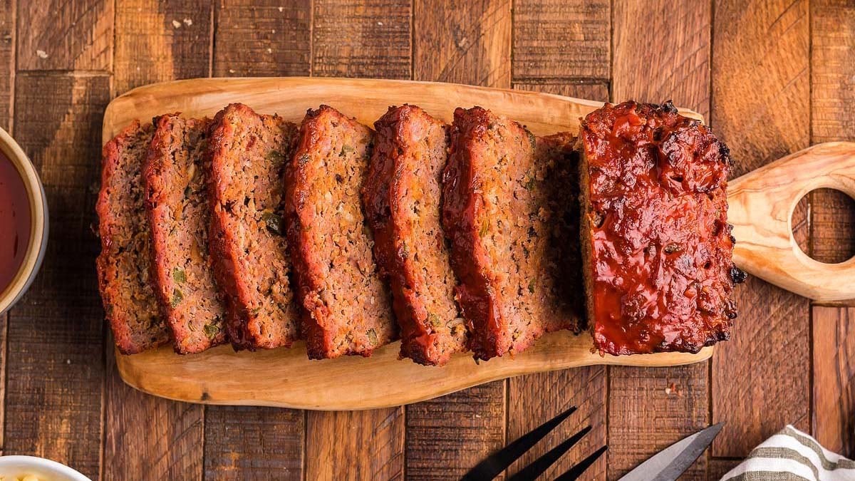 homemade juicy meatloaf on a wooden cutting board